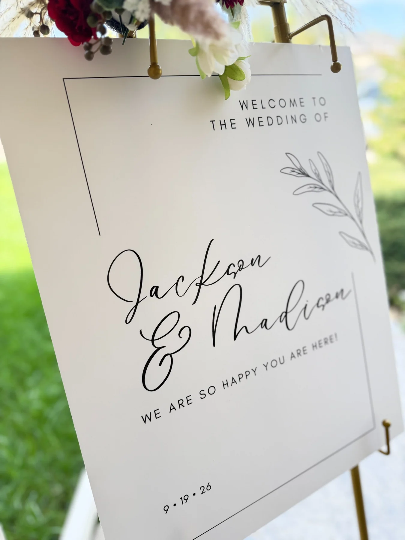 Close-up of custom wedding welcome sign on gold easel