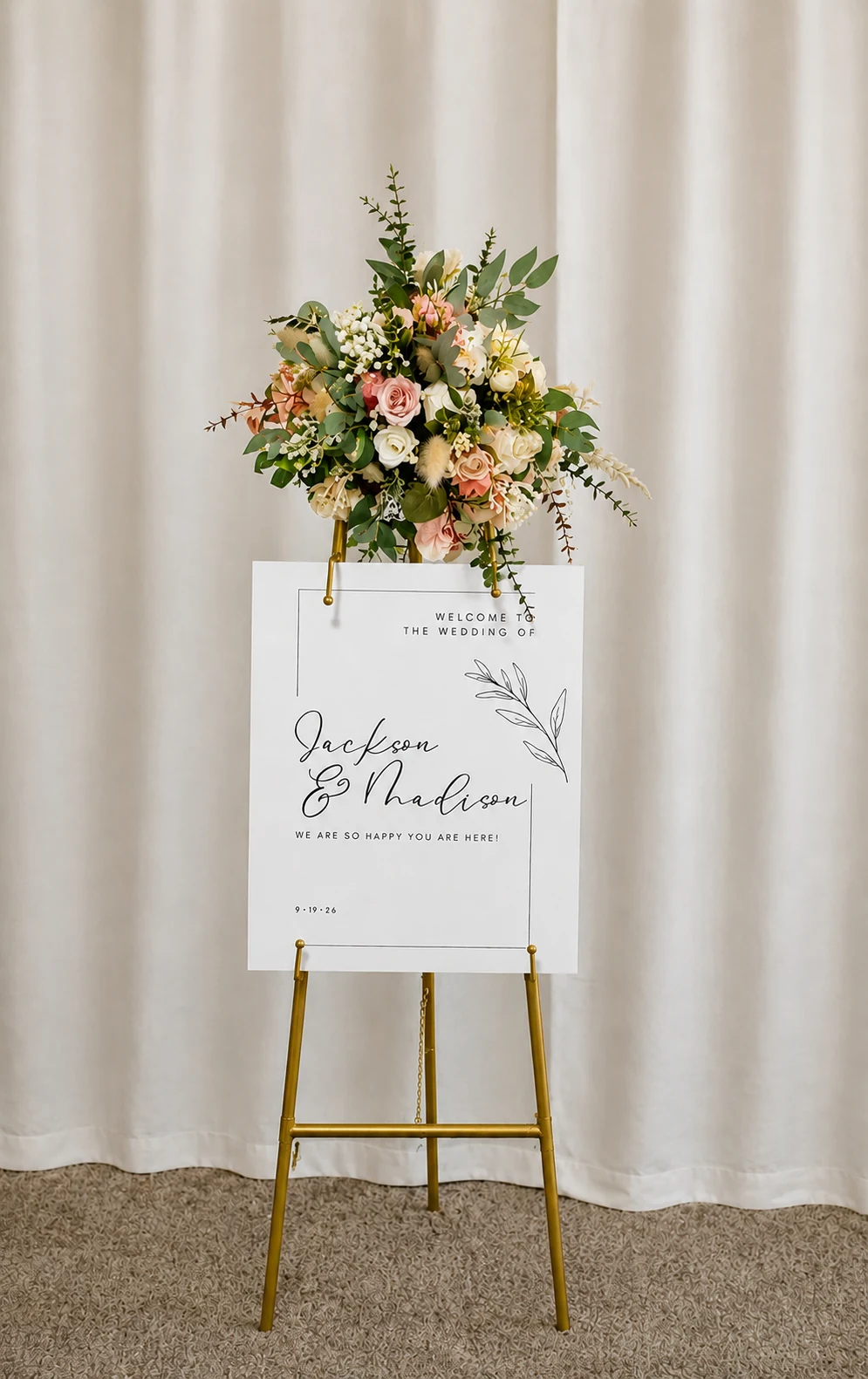 Blush and white floral arrangement on styled easel