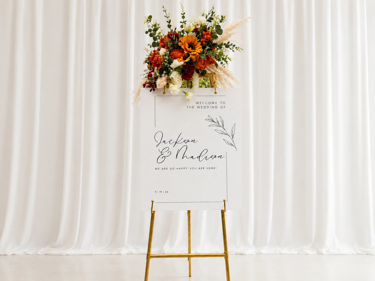 Fully styled wedding welcome easel in front of a white studio curtain